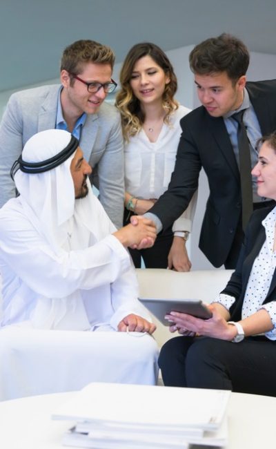 Executive,Business,Team,Having,Conversation,With,A,Arab,Businessman